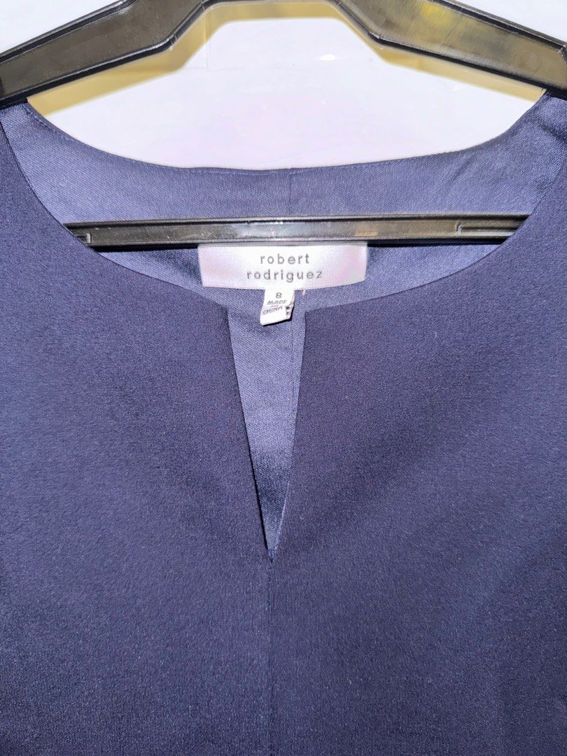 Robert Rodriguez Navy Office Dress Size 8 (Category: Dresses) located in Mandaluyong City. Submitted by wpitw (Listing ID 1407412154, Image 3). Description: Elegant navy dress by Robert Rodriguez. Features a V-neckline and a tiered skirt design with dark navy ribbon detailing. The dress is sleeveless and has a fitted bodice that flows into a flared skirt. Size 8..
