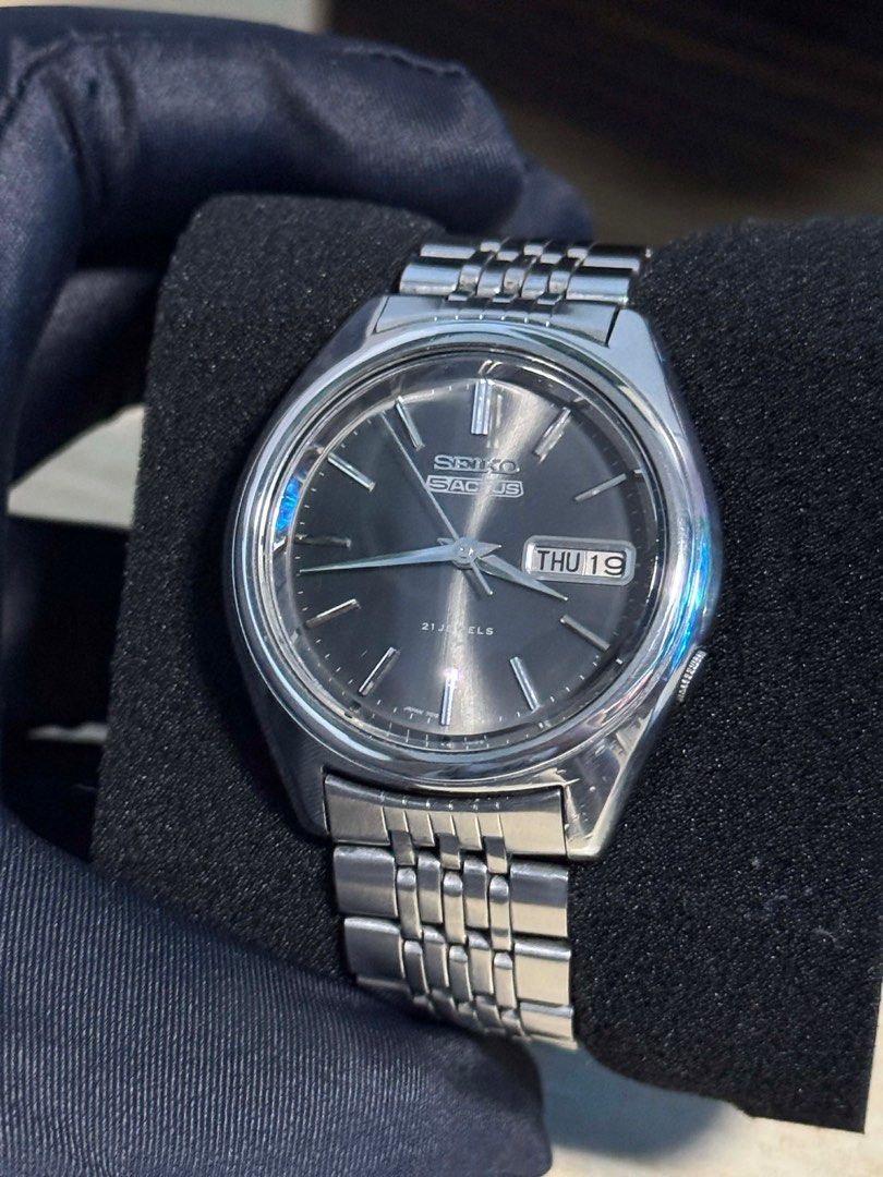 Seiko Actus (Category: Men's Watches) located in Caloocan City. Submitted by decluttervette (Listing ID 1407539509, Image 2). Description: Vintage Seiko 5 Actus 7019-7060 – Circa 1975 Model: Seiko 5 Actus 7019-7060 Year: Circa 1975 Movement: Automatic Seiko Cal. 7019 (21 jewels) Case: 36mm stainless steel Dial: Dark sunburst with applied indices Crystal: Acrylic Bracelet: Original Seiko stainless steel Features: Day-date complication (Kanji & Eng