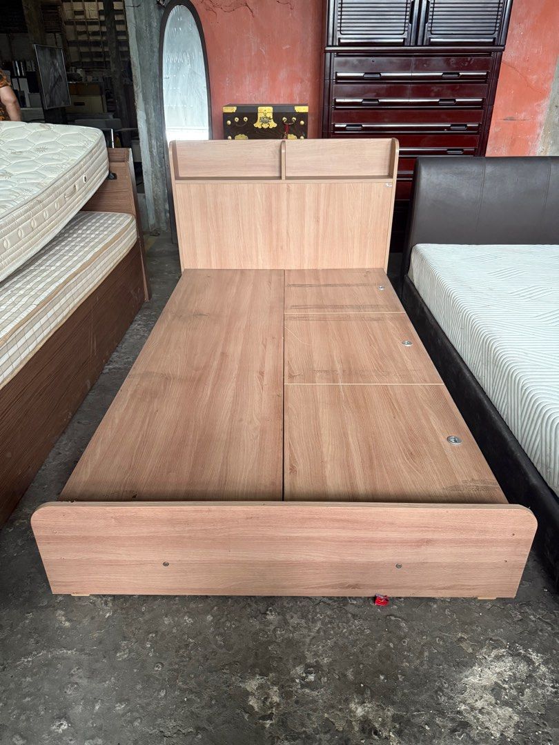 Semi double Bed Frame with Storage (Category: Bed Frames & Mattresses) located in Angeles City. Submitted by maryannmar33098 (Listing ID 1407524749, Image 2). Description: Single bed frame with headboard and built-in storage compartments. Features a light wood finish. The bed frame has multiple storage drawers accessible by lifting the bed platform. Includes a mattress. Perfect for maximizing space in a small room..
