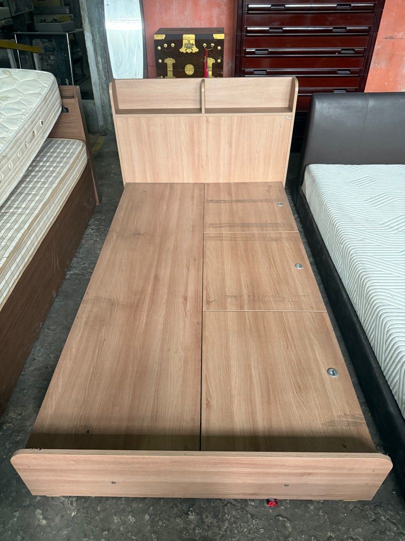 Semi double Bed Frame with Storage (Category: Bed Frames & Mattresses) located in Angeles City. Submitted by maryannmar33098 (Listing ID 1407524749, Image 3). Description: Single bed frame with headboard and built-in storage compartments. Features a light wood finish. The bed frame has multiple storage drawers accessible by lifting the bed platform. Includes a mattress. Perfect for maximizing space in a small room..