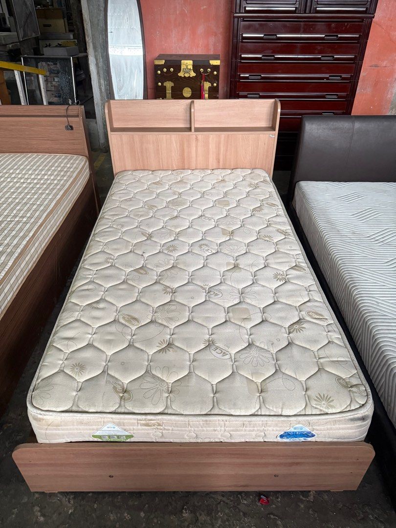 Semi double Bed Frame with Storage (Category: Bed Frames & Mattresses) located in Angeles City. Submitted by maryannmar33098 (Listing ID 1407524749, Image 1). Description: Single bed frame with headboard and built-in storage compartments. Features a light wood finish. The bed frame has multiple storage drawers accessible by lifting the bed platform. Includes a mattress. Perfect for maximizing space in a small room..