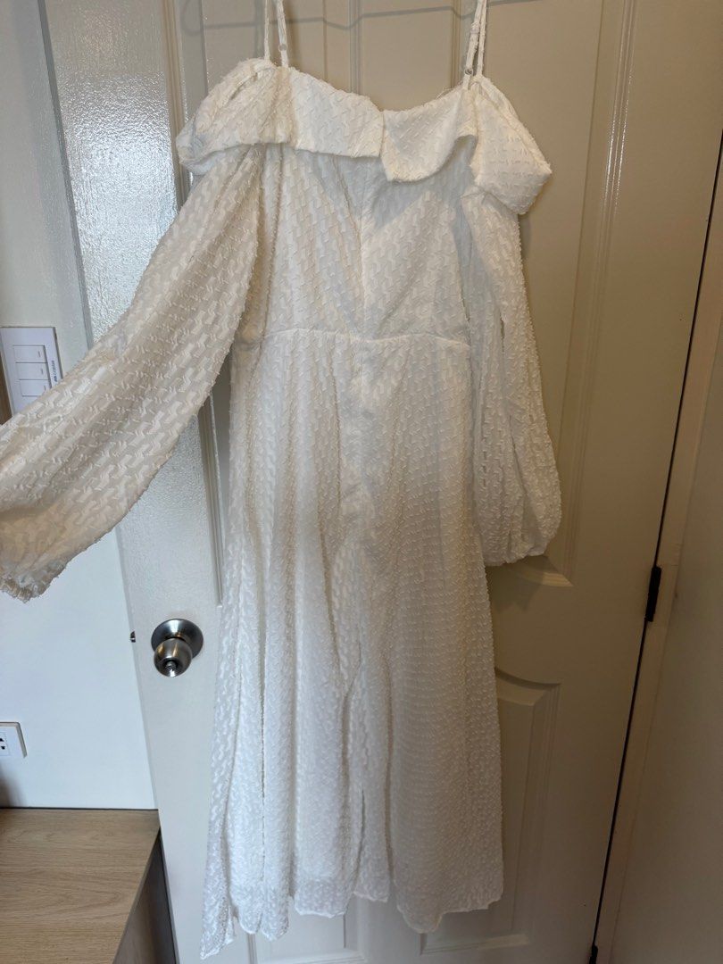 Shein Off-Shoulder White Dress (Category: Dresses) located in Cavite. Submitted by cielinesid (Listing ID 1407562522, Image 3). Description: Elegant white dress from Shein. Features an off-shoulder design with spaghetti straps and long, puffy sleeves. The dress has a textured fabric and a flattering A-line silhouette. It includes a collar detail and a fitted waist. Size is Large, with a 40-inch bust and a 31.5-inch waist..