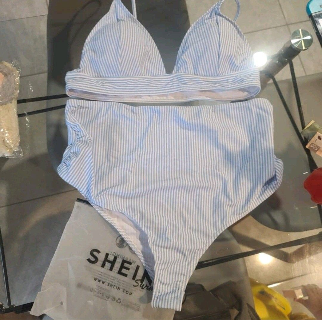 Shein Striped High Waist Bikini Set (Category: Bikinis & Swimsuits) located in Manila. Submitted by monaaa03 (Listing ID 1407558344, Image 1). Description: Light blue and white striped bikini set from Shein. Features a triangle top and high-waisted bottoms. The bottoms have a ruched detail on the sides. Perfect for the beach or pool..