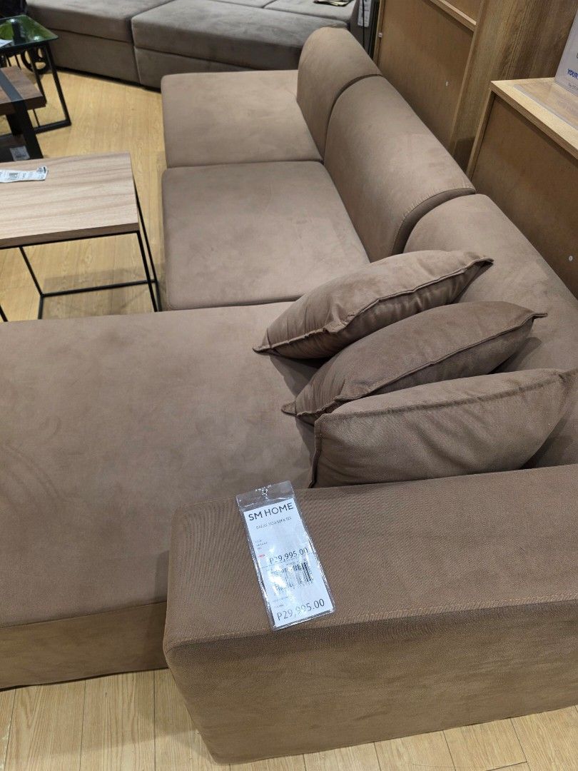 SM Home Sectional Sofa (Category: Sofas) located in Quezon City. Submitted by alramos91 (Listing ID 1407412608, Image 3). Description: - SM Home sectional sofa - Neutral brown color - L-shaped design - Includes throw pillows - Soft, suede-like material - Perfect for lounging and entertaining - Price tag: ₱29,995.00.