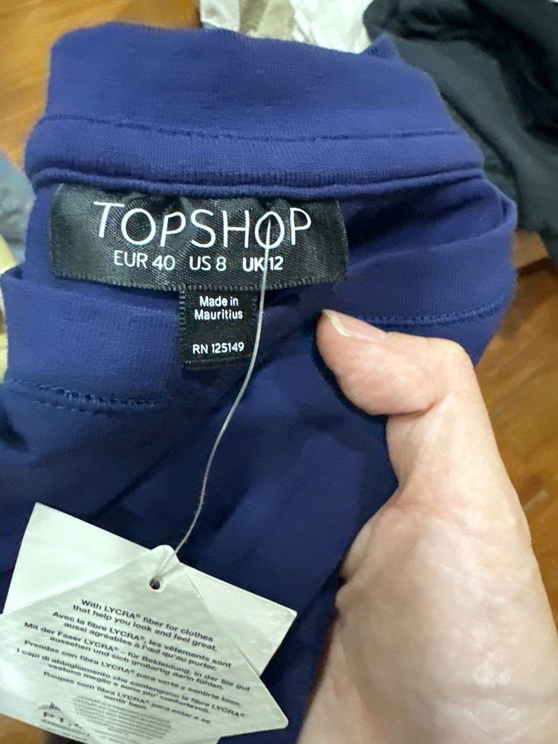 Topshop Blue Dress (Category: Dresses) located in Quezon City. Submitted by struddels (Listing ID 1407476448, Image 2). Description: Topshop dress is a beautiful shade of blue. It features a round neckline and short sleeves. The dress has a fitted bodice that flows into a flared skirt. The tag indicates the size is EUR 40, US 8, and UK 12. Made in Mauritius..