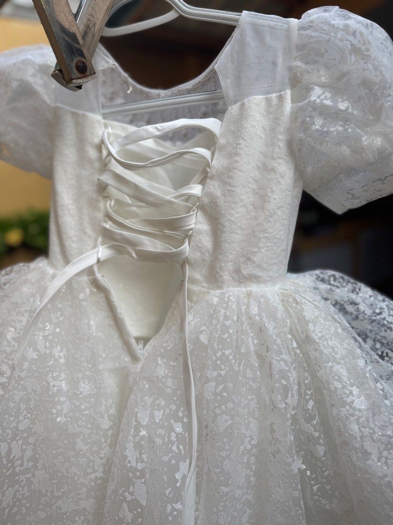 White Party Dress - Size 110 (Category: Babies & Kids Fashion) located in Cavite. Submitted by burayyy (Listing ID 1407563938, Image 3). Description: - White party dress - Size 110 - Layered skirt - Embellished bodice - Short, puffy sleeves - Lace-up back for adjustable fit - Delicate, textured overlay - Perfect for special occasions good condition. only worn once. my kid outgrown it. perfect for formal occassions please arrange your own pick up.