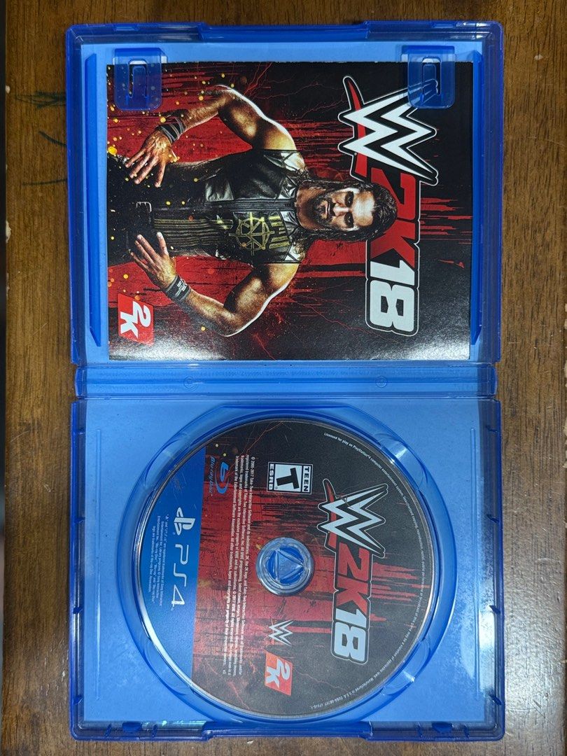 WWE 2K18 - PS4 Game (Category: PlayStation) located in Santa Rosa. Submitted by cheesecols (Listing ID 1407527737, Image 3). Description: WWE 2K18 for PlayStation 4. Features include MyCareer, Road to WrestleMania, and a Superstar roster. Includes a new graphics engine and commentary system. Offers a variety of game modes, including Create-a-Superstar and Universe mode. Features a soundtrack with artists like Kanye West and Bruno Mars. Like new ₱