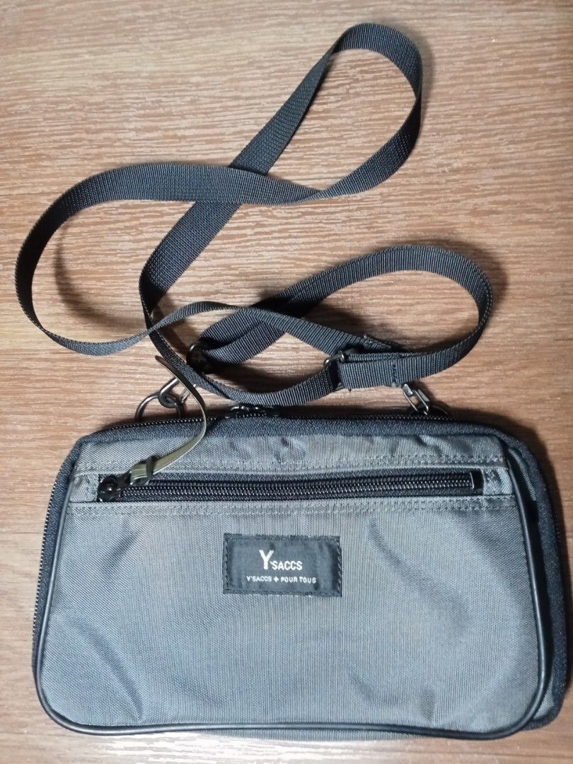 Y's Sacs Crossbody Bag (Category: Cross-body Bags) located in Makati City. Submitted by kuysman (Listing ID 1407453994, Image 1). Description: - Y's Sacs crossbody bag - Adjustable strap - Multiple compartments - Zippered closure - Black exterior - Gray interior - Features a small "Made in Japan" tag - Small Y's Sacs logo on the front only sensible questions are entertained actual measurement 5 x 10" (folded) like new 1 left .
