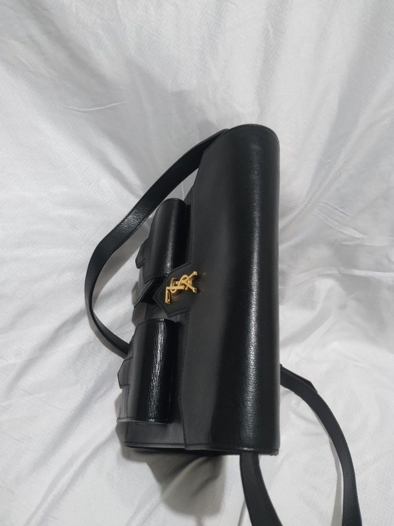 YSL Saint Laurent Shoulder Bag Black Leather (Category: Luxury Bags & Wallets) located in Pasig City. Submitted by aecollection03 (Listing ID 1407533927, Image 3). Description: - AUTHENTIC YSL Saint Laurent shoulder bag - Black leather - Two front pockets - Flap closure - Gold-tone logo and hardware(100%) - L9.5"×H9"×4" Strap drop 11-26" - Lined interior - Feet on the bottom -used once and stored..