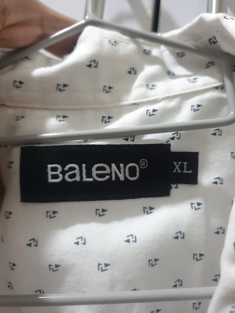 Baleno White Printed Shirt - XL (Category: Tshirts & Polo Shirts ) located in Manila. Submitted by sansairo (Listing ID 1410739706, Image 2). Description: - Baleno white shirt - Size: XL - Features a subtle, repeating print - Classic button-down style - Includes a collar - Single chest pocket - Made from lightweight fabric - Ideal for warm weather.