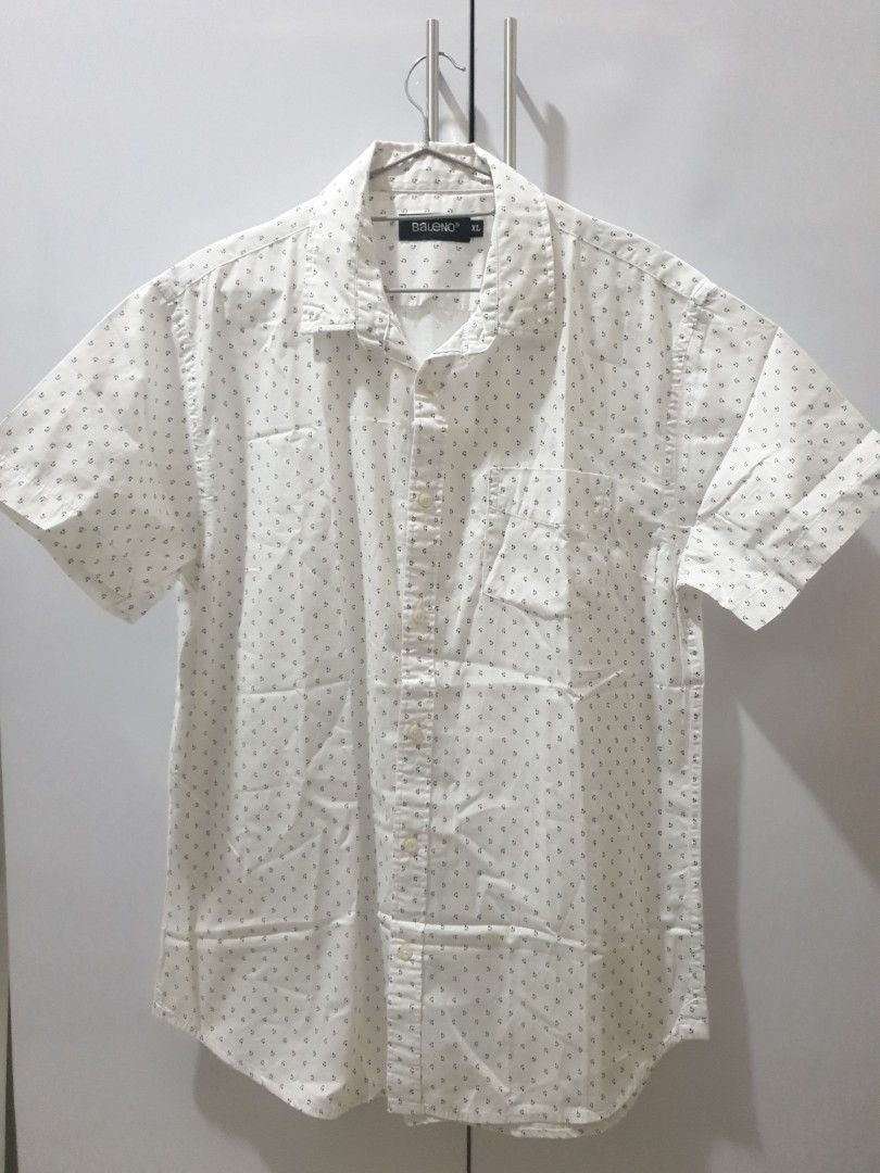Baleno White Printed Shirt - XL (Category: Tshirts & Polo Shirts ) located in Manila. Submitted by sansairo (Listing ID 1410739706, Image 1). Description: - Baleno white shirt - Size: XL - Features a subtle, repeating print - Classic button-down style - Includes a collar - Single chest pocket - Made from lightweight fabric - Ideal for warm weather.