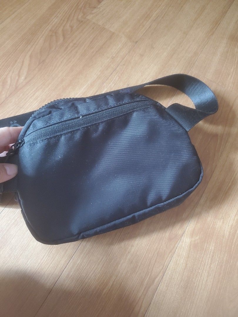 Black Sling Bag with Zipper Closure (Category: Cross-body Bags) located in Manila. Submitted by _prelovedbyk_ (Listing ID 1410726890, Image 3). Description: - Black sling bag - Zippered main compartment - Adjustable strap - Interior mesh pocket - Durable, water-resistant material - Compact and practical design.