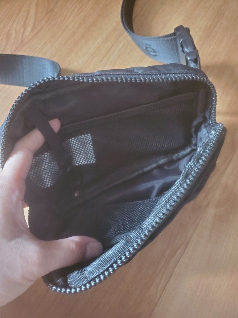 Black Sling Bag with Zipper Closure (Category: Cross-body Bags) located in Manila. Submitted by _prelovedbyk_ (Listing ID 1410726890, Image 2). Description: - Black sling bag - Zippered main compartment - Adjustable strap - Interior mesh pocket - Durable, water-resistant material - Compact and practical design.