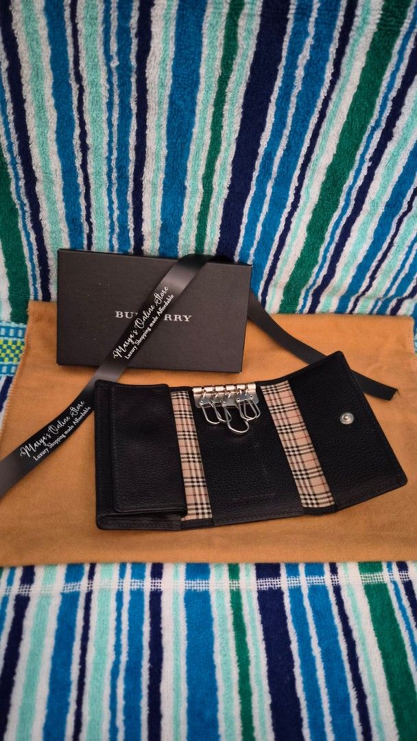 Burberry Key Holder (Category: Luxury Bags & Wallets) located in Quezon City. Submitted by marya_s (Listing ID 1410766406, Image 3). Description: - Authentic Burberry key holder - Classic check pattern design - Multiple key rings - Secure snap closure - Comes with original box and ribbon - Exterior: Black leather - Interior: Iconic Burberry check.