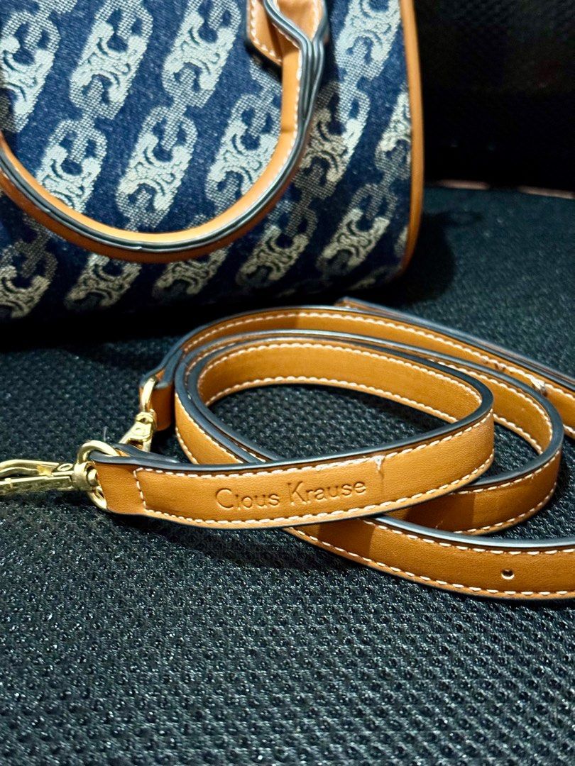 Celine-style Denim Handbag with Shoulder Strap (Category: Luxury Bags & Wallets) located in Tanza. Submitted by mypreloved-64cc0b (Listing ID 1410811991, Image 2). Description: - Denim handbag by Cious Krause - Chain-like design - Detachable brown shoulder strap - Brown leather accents - Gold-colored hardware - Top handle - Rectangular shape.