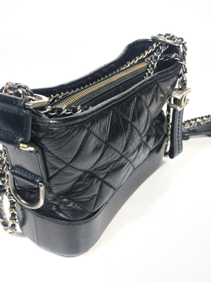 Chanel Gabrielle Mini Hobo Bag Black (Category: Luxury Bags & Wallets) located in Manila. Submitted by callmetin (Listing ID 1410814719, Image 3). Description: Chanel Gabrielle Hobo bag in black. Features a quilted design with a chain strap and a detachable leather strap. Includes a zipper closure and a Chanel logo charm. The interior is lined with pink fabric and includes a serial number tag. Made in Italy..