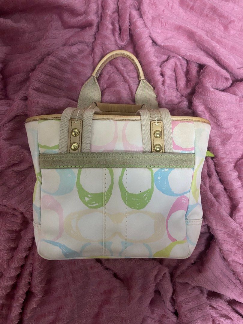Coach Multicolor Handbag (Category: Luxury Bags & Wallets) located in Santiago. Submitted by jmayaa (Listing ID 1410824845, Image 2). Description: - Coach handbag with a colorful design - Zip closure - Dual top handles - Detachable tag - Interior small pocket - Made in China - Minor wear on handles and base.