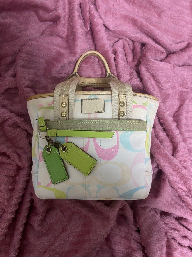 Coach Multicolor Handbag (Category: Luxury Bags & Wallets) located in Santiago. Submitted by jmayaa (Listing ID 1410824845, Image 1). Description: - Coach handbag with a colorful design - Zip closure - Dual top handles - Detachable tag - Interior small pocket - Made in China - Minor wear on handles and base.