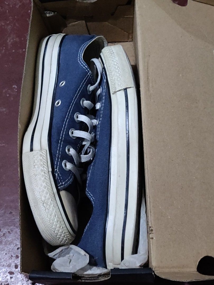 Converse Chuck Taylor All Star Low Navy (Category: Sneakers) located in Valenzuela. Submitted by jaypee.jaypee (Listing ID 1410900715, Image 3). Description: - Classic navy blue Converse Chuck Taylor All Star low-top sneakers - Features the iconic white rubber toe cap and sole - Unisex - Comes with the original box - Includes white laces - Converse All Star logo visible on insole - Shoes appear well-maintained.