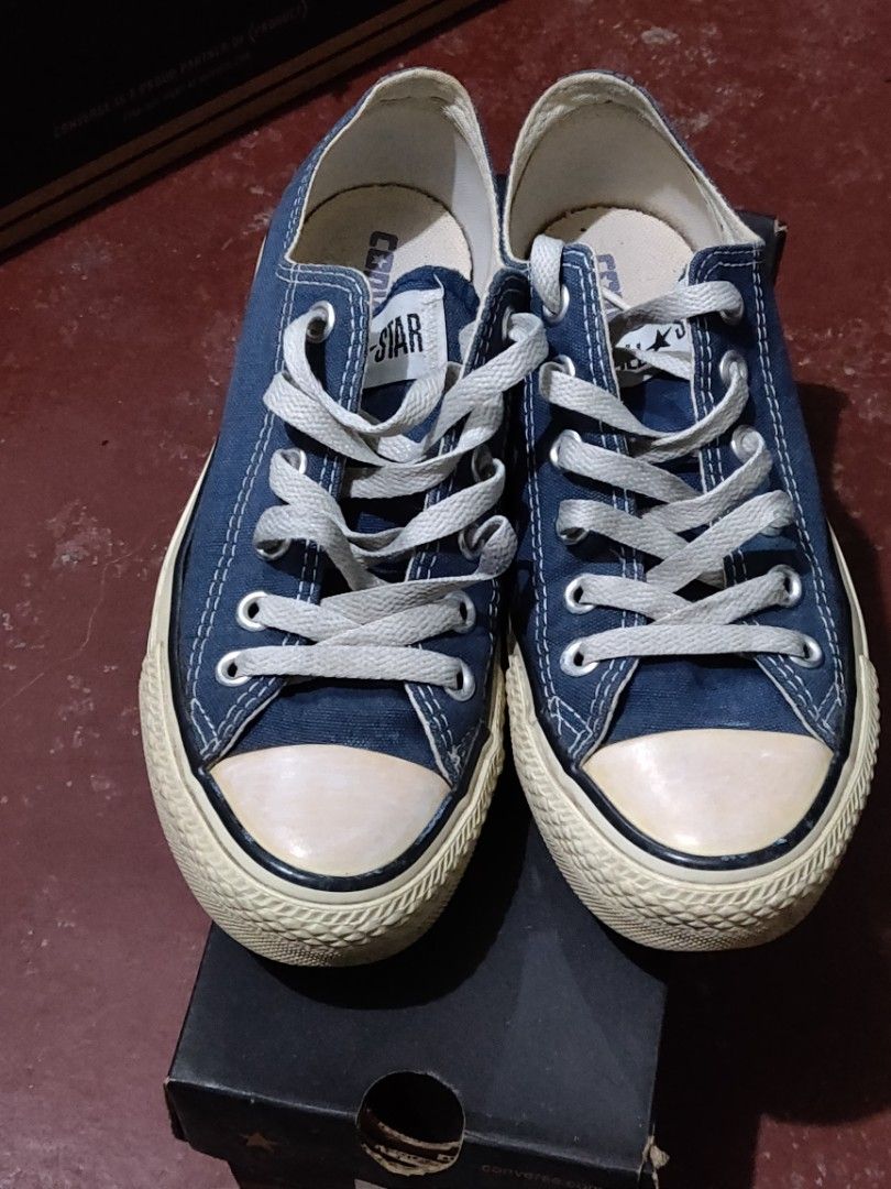Converse Chuck Taylor All Star Low Navy (Category: Sneakers) located in Valenzuela. Submitted by jaypee.jaypee (Listing ID 1410900715, Image 1). Description: - Classic navy blue Converse Chuck Taylor All Star low-top sneakers - Features the iconic white rubber toe cap and sole - Unisex - Comes with the original box - Includes white laces - Converse All Star logo visible on insole - Shoes appear well-maintained.