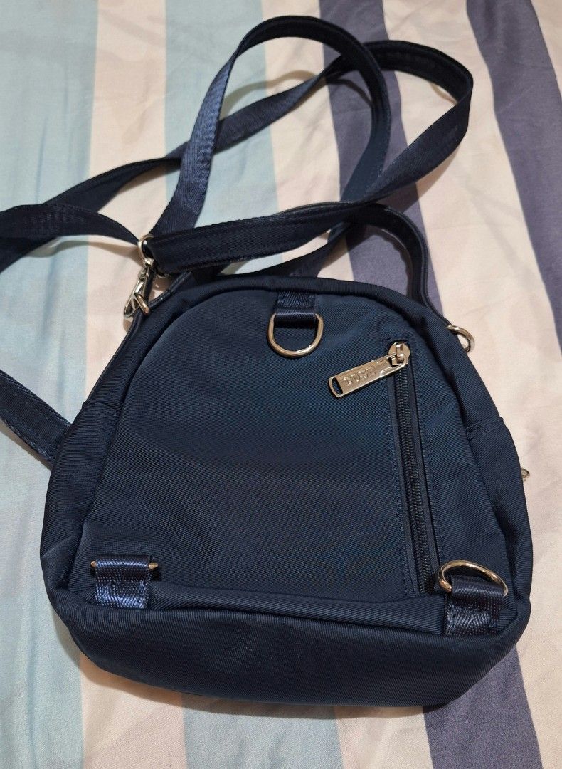 COSE Sling Bag (Category: Cross-body Bags) located in Quezon City. Submitted by prelovedbox2016 (Listing ID 1410764584, Image 2). Description: - Navy blue COSE sling bag - Zippered main compartment - Front pocket - Top handle - Adjustable shoulder strap - Gray fabric interior lining - Interior zippered pocket - Silver-toned hardware - COSE logo on front.