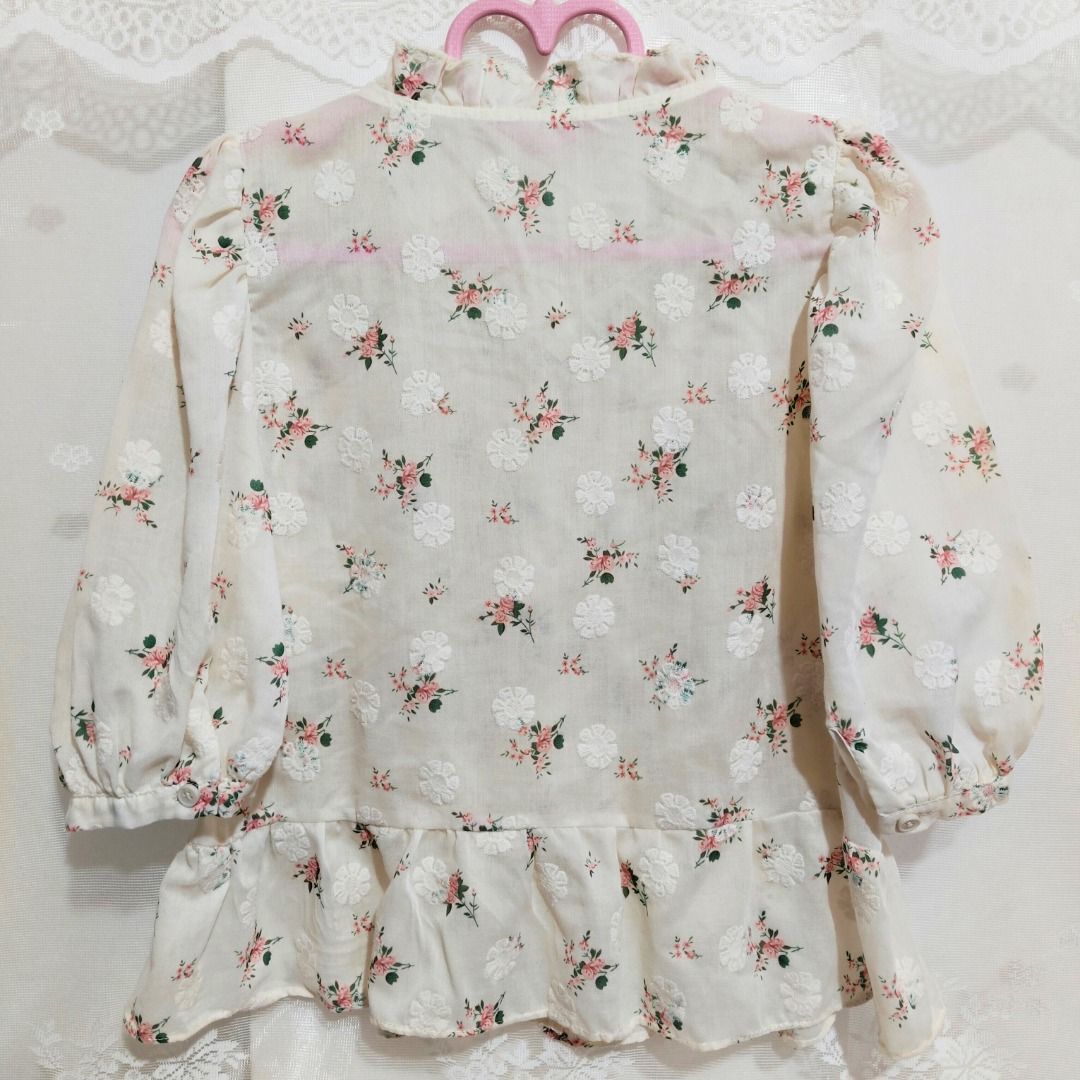 Cream Smocked Floral Button Down Peplum Blouse (Category: Blouses) located in Mandaluyong City. Submitted by princesspockets (Listing ID 1410861479, Image 2). Description: Premium top! The bodice has multiple smocking and working buttons. Features a ruffled mock neck and puff sleeves. Best fit: M-XL 🌸 FLAT LAY MEASUREMENTS 🌸 Bust: 32-40 in Length: 20 in 🌸 REMINDERS 🌸 - Thrifted / Preloved / Ukay, lightly washed. PLEASE MANAGE YOUR EXPECTATION