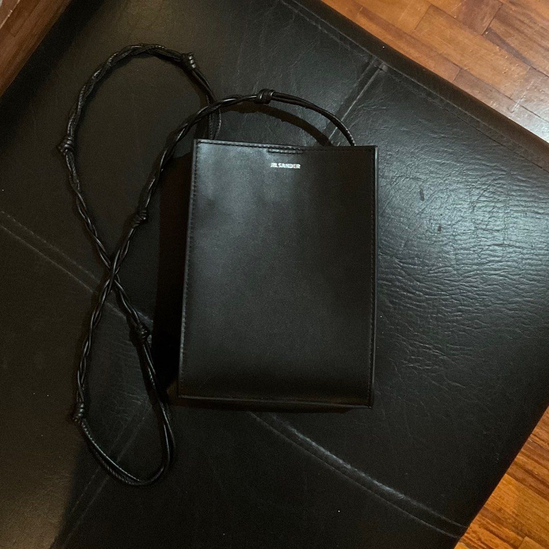 Jil Sander Black Leather Crossbody Bag (Category: Cross-body Bags) located in Paranaque City. Submitted by nadzdeclutters (Listing ID 1410840804, Image 3). Description: Can’t guarantee authenticity hence the price, but the bag itself is of great quality :-) DM me for more pictures! Auth is 30k+ 😆 RFS: Decluttering + not my style :( .