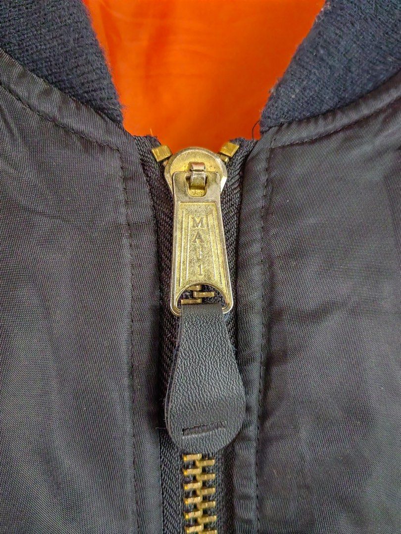 MA-1 Bomber Jacket (Category: Activewear) located in Trece Martires City. Submitted by kenzolois2004 (Listing ID 1410800365, Image 3). Description: Black MA-1 bomber jacket by Chic Elegant by Payvand. Features a reversible orange lining and a zip closure. The jacket has a size S label. Made in Korea. The jacket has a classic bomber silhouette with ribbed cuffs and hem. The jacket has a MAI zipper. Small on tag (large frame).
