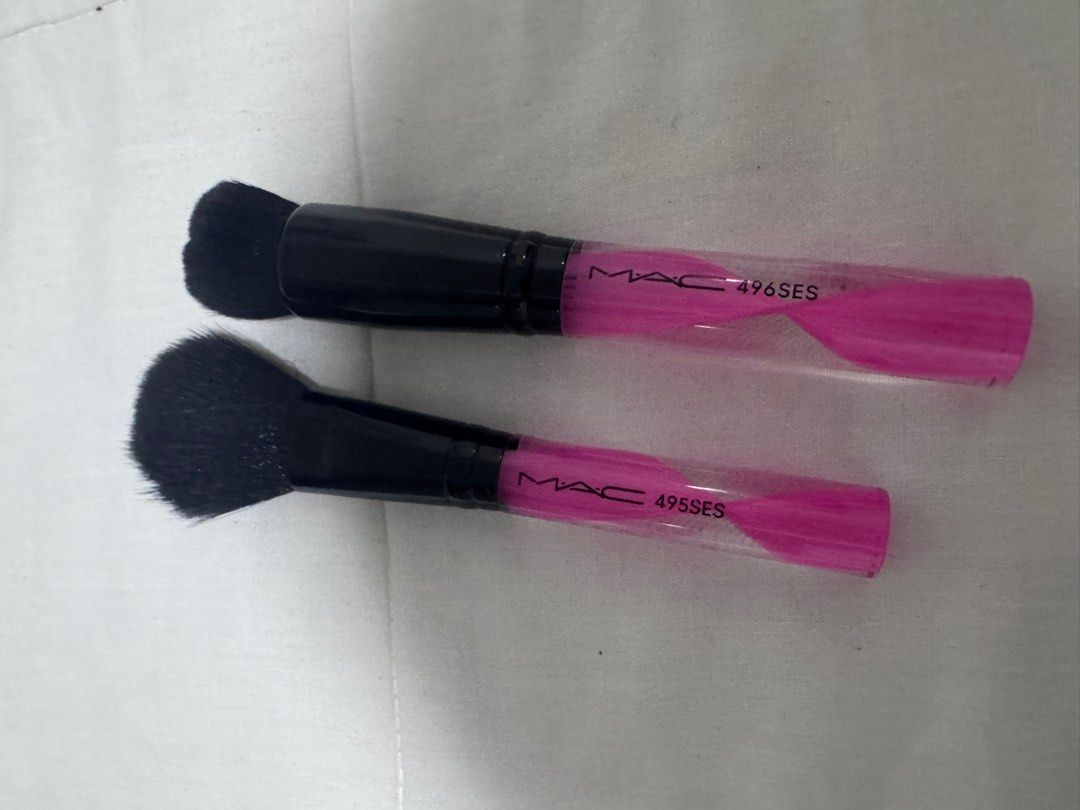 MAC 495SES & 496SES Makeup Brushes (Category: Makeup) located in Manila. Submitted by decluterthings888 (Listing ID 1410845123, Image 2). Description: - Set includes two MAC makeup brushes: 495SES and 496SES. - Features black bristles and black handles with pink accents. - Brushes are new and unused. - Still in original packaging..