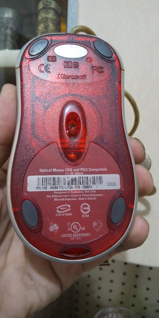 Microsoft Optical Mouse USB (Category: Mouse & Mousepads) located in Carmona. Submitted by rpute (Listing ID 1410752548, Image 3). Description: - Microsoft Optical Mouse - Classic design - Red translucent base - Black top with scroll wheel - USB connection - Gold-colored cable - Suitable for everyday use.