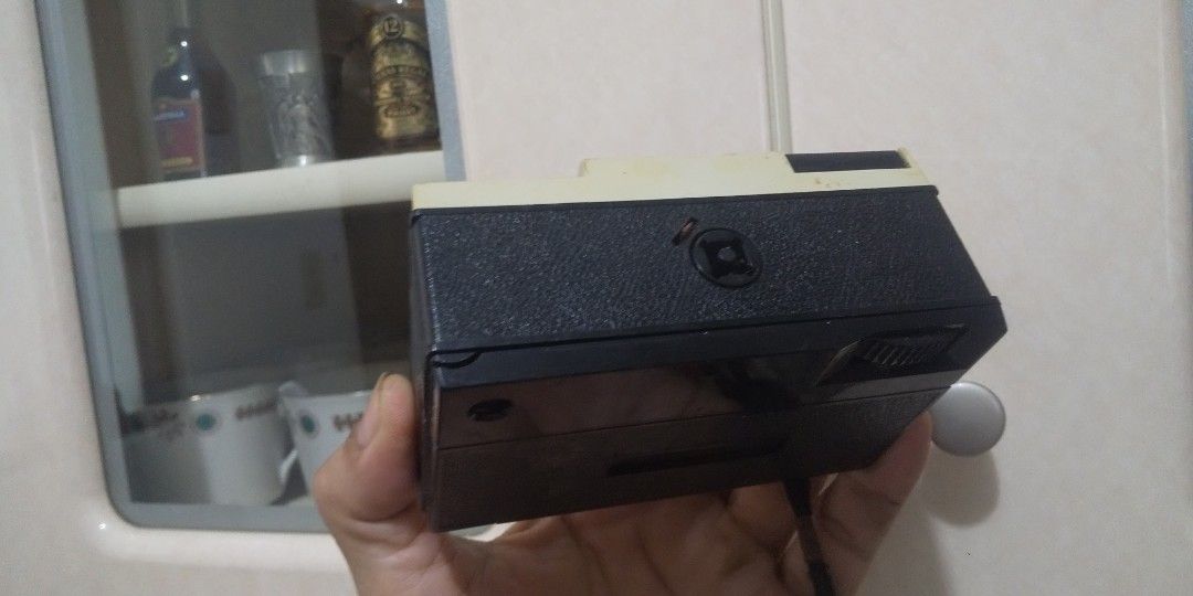 Vintage X-126 Camera (Category: Cameras) located in Carmona. Submitted by rpute (Listing ID 1410746989, Image 3). Description: Vintage X-126 camera. It has a black and beige color scheme. The camera has a lens, a viewfinder, and a flash. The camera's back can be opened..