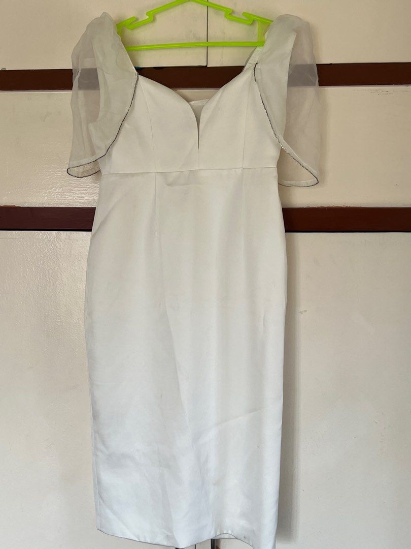 White Dress with Sheer Sleeves (Category: Dresses) located in Manila. Submitted by decluttermnlmd (Listing ID 1410729993, Image 2). Description: - White dress - Sweetheart neckline - Sheer sleeves with black trim - Fitted silhouette - Knee-length - Satin-like fabric - Ideal for special occasions This was bought in SM Mags for 3,500 pesos, used once and cleaned. May need additional cleaning for use since finit ulit pero di na kasya. For Medium to 