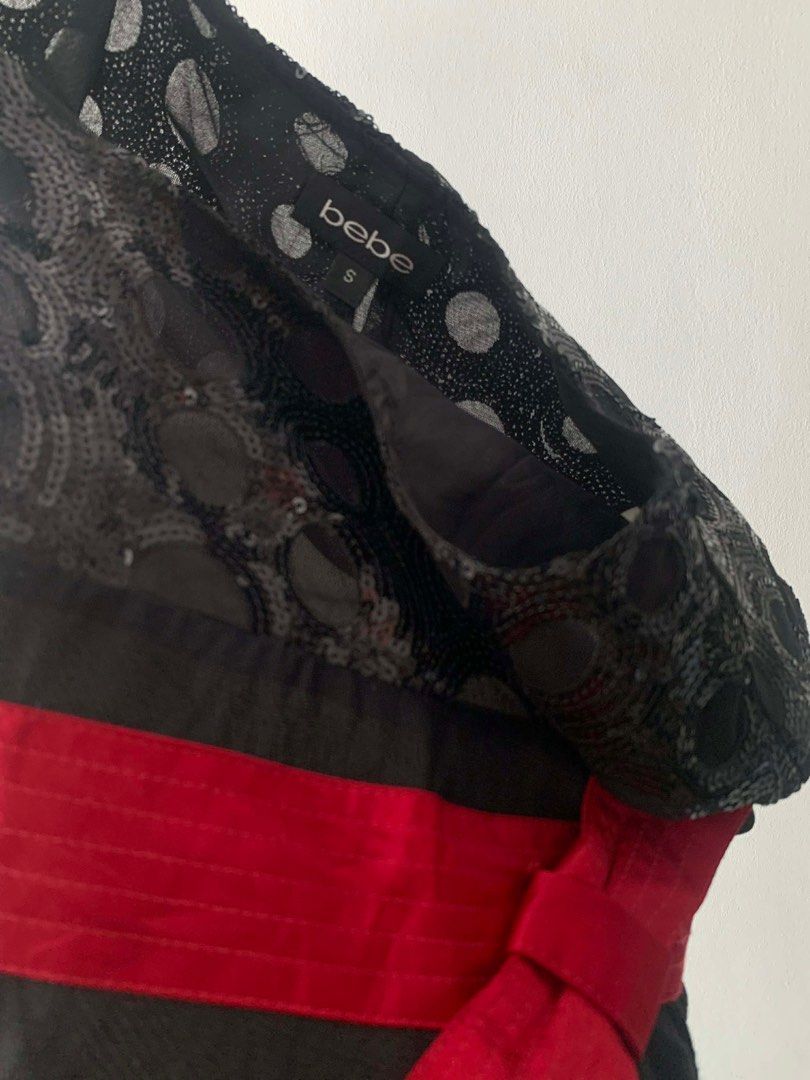 Bebe Black Dress with Red Bow (Category: Dresses) located in Cavite. Submitted by cssndrakateg (Listing ID 1410972147, Image 3). Description: - Bebe black dress - Red bow detail - Sequined lace neckline - Size S - Flattering silhouette - Perfect for special occasions - Zipper closure at the back.