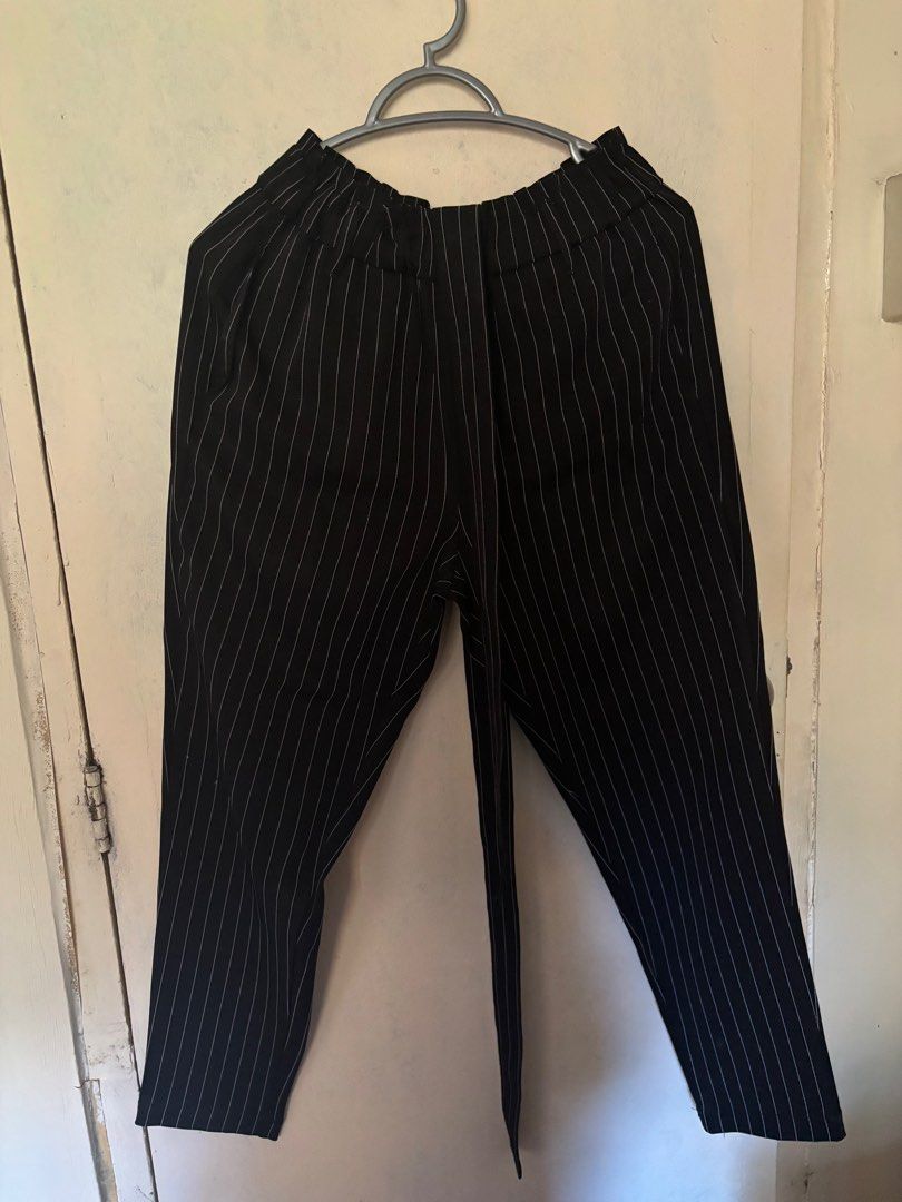Black Striped Pants with Belt (Category: Other Bottoms) located in Valenzuela. Submitted by popyard (Listing ID 1410939318, Image 2). Description: - Black pants with vertical white stripes - High-waisted design - Elastic waistband - Includes matching belt - Straight leg cut - Lightweight fabric - Suitable for casual and semi-formal occasions.