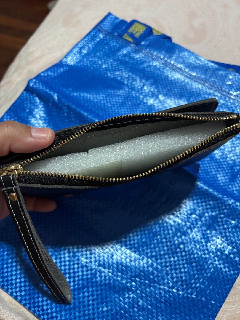 Black Wallet with Wrist Strap (Category: Wallets & Card holders) located in Makati City. Submitted by vanbustling (Listing ID 1410918042, Image 3). Description: - Black wallet with wrist strap - Snap closure - Multiple card slots - Clear ID window - Zippered compartment - White stitching for contrast - Made of leather-like material.