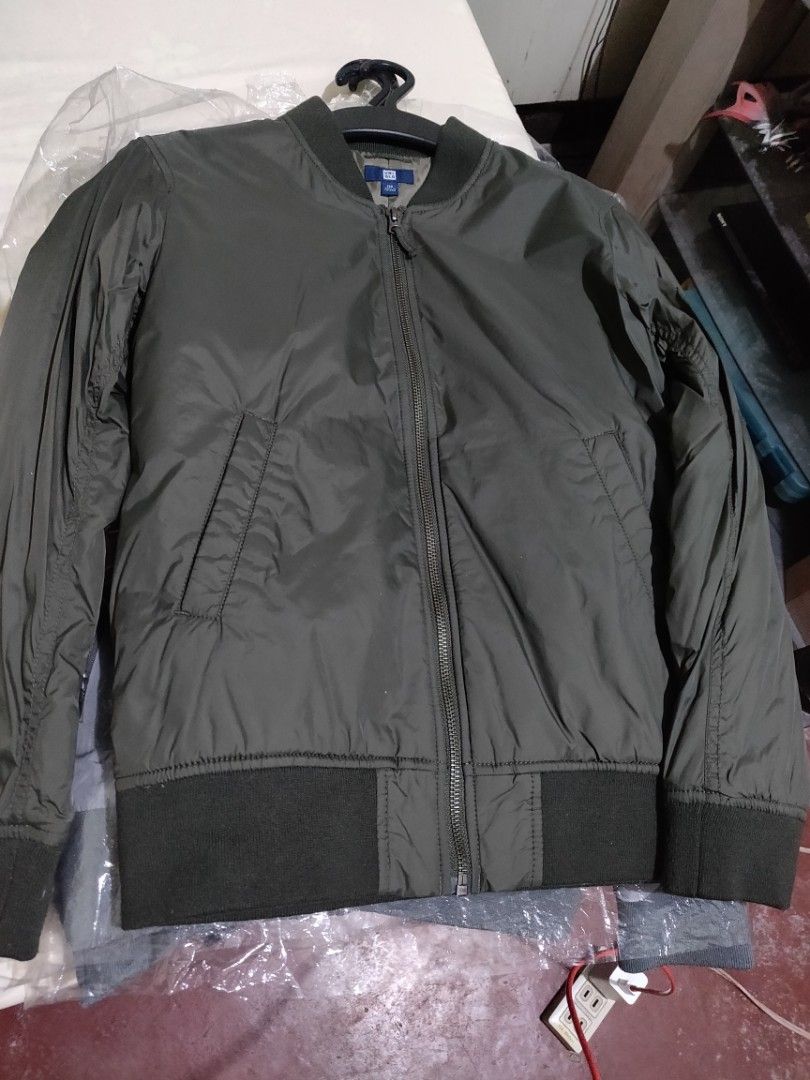 Bomber Jacket - Black (Category: Coats, Jackets and Outerwear) located in Valenzuela. Submitted by jaypee.jaypee (Listing ID 1410901326, Image 2). Description: - Classic bomber jacket design - Available in olive green and black - Ribbed collar, cuffs, and hem - Zip-up front - Two front pockets - Smooth, possibly nylon-like material - Ideal for casual wear - Kids boys.