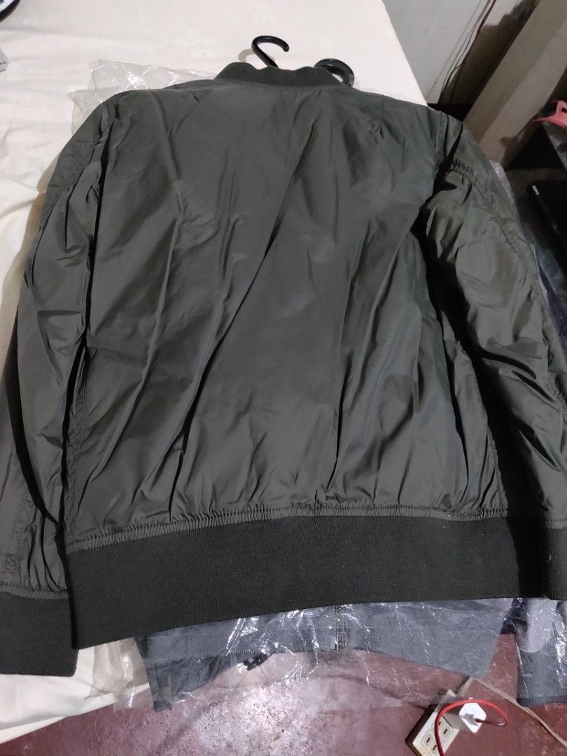 Bomber Jacket - Black (Category: Coats, Jackets and Outerwear) located in Valenzuela. Submitted by jaypee.jaypee (Listing ID 1410901326, Image 1). Description: - Classic bomber jacket design - Available in olive green and black - Ribbed collar, cuffs, and hem - Zip-up front - Two front pockets - Smooth, possibly nylon-like material - Ideal for casual wear - Kids boys.