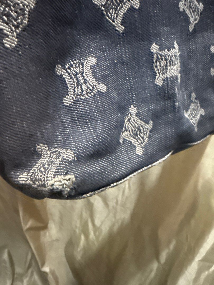 Celine Denim Tote Bag (Category: Luxury Bags & Wallets) located in Taguig. Submitted by sossypreloved (Listing ID 1411067205, Image 2). Description: - Celine denim tote bag - Repeating logo pattern - Black leather handles and trim - Floral print lining - Zipper closure - Interior pocket - Signs of wear on corners.