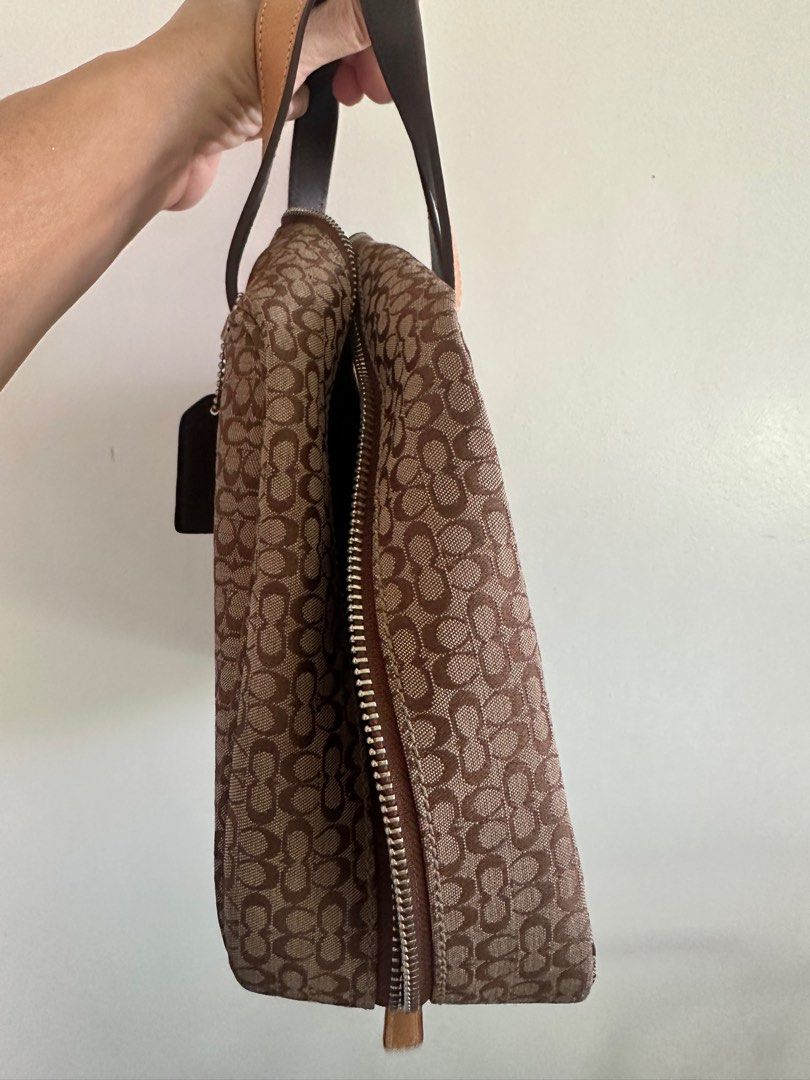 Coach Brown Signature Handbag (Category: Shoulder Bags) located in Makati City. Submitted by Tyangge (Listing ID 1410915100, Image 3). Description: - Authentic Coach handbag - Brown signature pattern - Top zip closure - Dual top handles - Detachable hang tag - Interior with multiple compartments - Some wear on leather accents - Includes Coach hang tag.