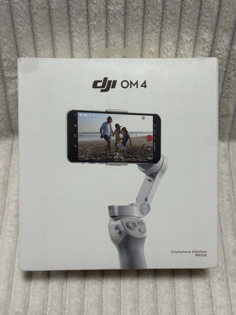 DJI OM 4 (Osmo Mobile 4) Smartphone Gimbal Stabilizer (Category: Gimbals & Stabilizers ) located in Dasmarinas. Submitted by behindthehype_sg (Listing ID 1411073805, Image 1). Description: The DJI OM 4 (Osmo Mobile 4) is a foldable, 3-axis smartphone gimbal stabilizer that uses a new magnetic quick-release system to quickly attach and balance your phone, making it easier to capture ultra-smooth, professional-looking videos and photos. It’s design