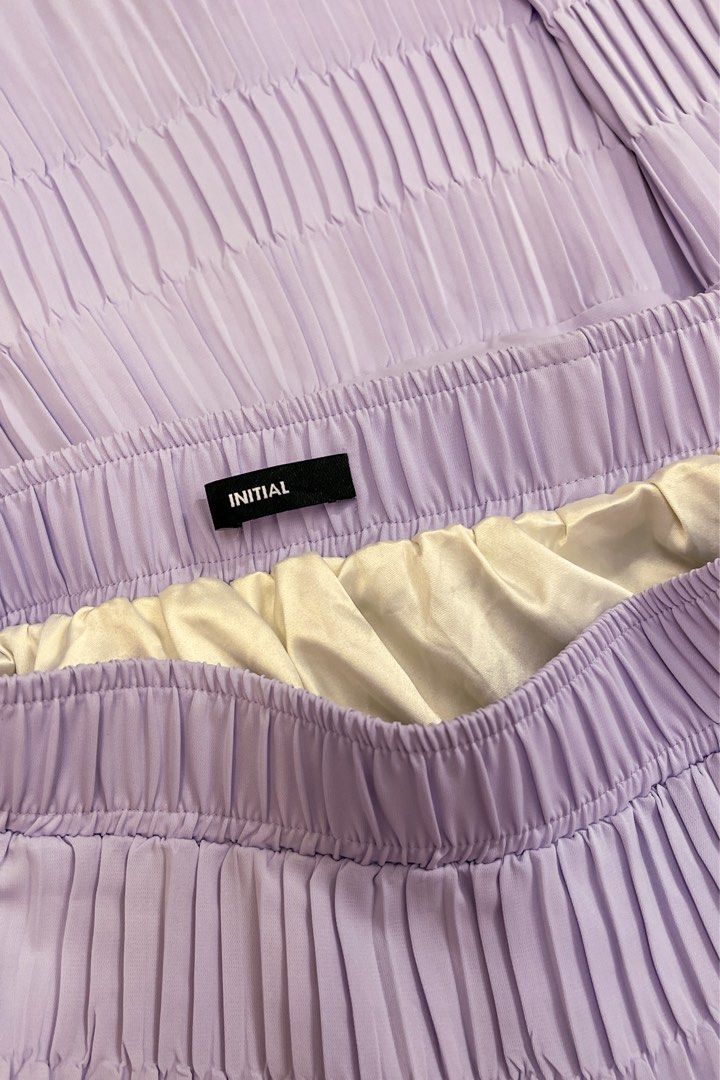 INITIAL Pleated Skirt (Category: Skirts) located in Pasig City. Submitted by space.byp (Listing ID 1410986527, Image 3). Description: INITIAL Pleated Skirt Soft lilac pleated skirt from INITIAL featuring a lightweight, flowy silhouette with an elasticized waistband for a comfortable fit. Designed with tiered pleats that move beautifully and give an effortless, feminine look. Fully lined and made from smooth, airy fabric—perfect for casual days, b