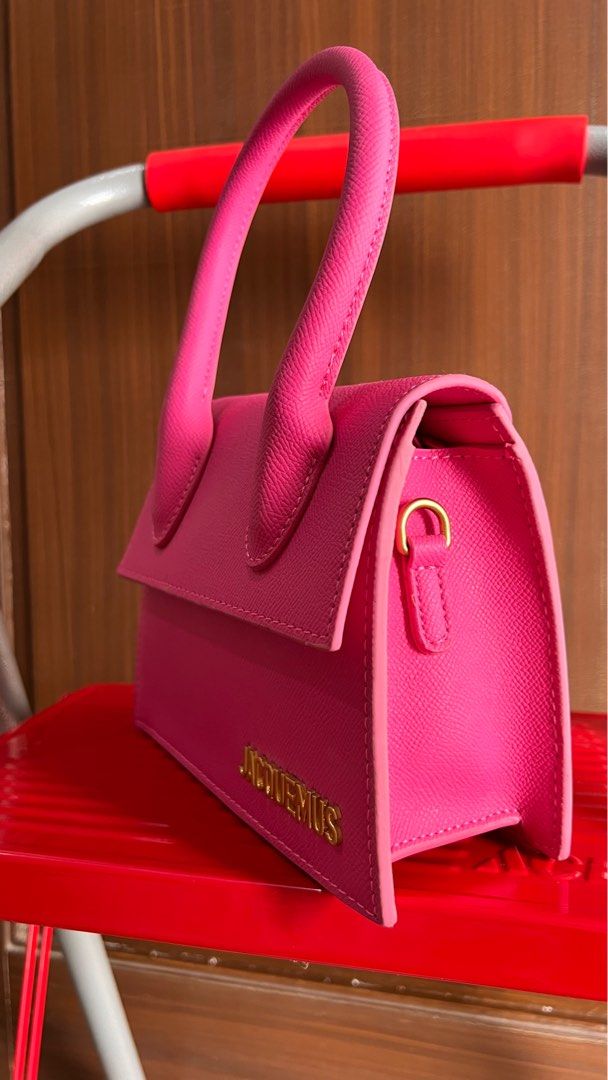 Jacquemus Le Chiquito Mini Bag - Pink (Category: Luxury Bags & Wallets) located in Licab. Submitted by gorgbagsph (Listing ID 1411058940, Image 2). Description: - Preloved Jacquemus Le Chiquito Mini Bag. - Color: Pink. - Features a structured rectangular shape. - Top handle for easy carrying. - Secure magnetic closure. - Gold-tone Jacquemus logo on the front. - Interior lined with neutral-colored fabric. - Perfect mini bag for essentials. - Styli