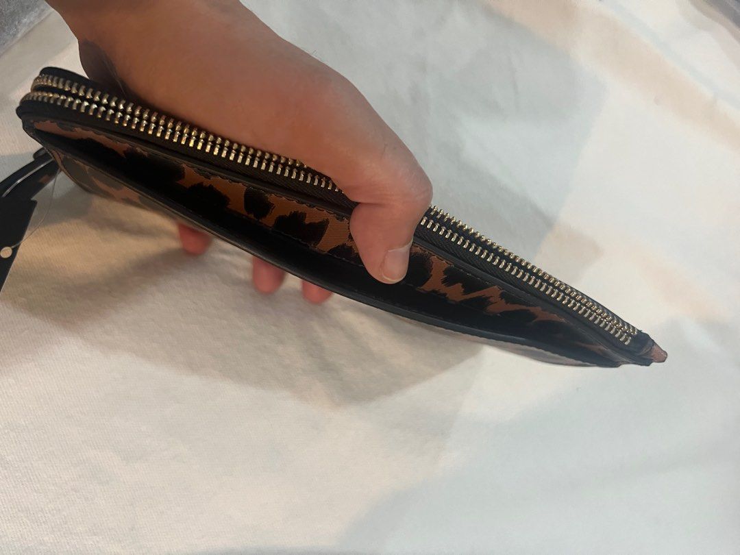 Kate Spade Lucy Med Zip Wristlet (Category: Luxury Bags & Wallets) located in Quezon City. Submitted by bitsxpieces (Listing ID 1411034951, Image 3). Description: - Authentic Kate Spade Lucy Med Zip Wristlet - Stylish leopard print design - Features a convenient wrist strap - Black interior with zip closure - Comes with original tags - Comparable value: CAD 169 / USD 139 Available in other designs: (see last 3 photos) -candied cherry (red) -black