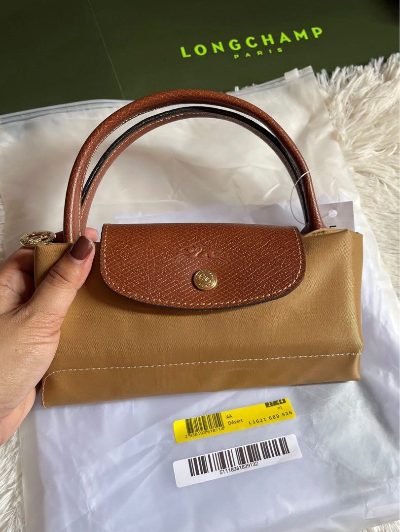 Longchamp Le Pliage Handbag - Short Handle (Category: Luxury Bags & Wallets) located in Manila. Submitted by decluttering2k24 (Listing ID 1410945401, Image 1). Description: Longchamp Le Pliage Small (Short Handle) Purchased via an IG SG outlet pasabuy. Authenticity not guaranteed, though seller claimed it was from an SG outlet. Includes: •Paper bag •Dust bag Condition: Visible stain • signs of usage Once price is agreed upon, detailed photos will
