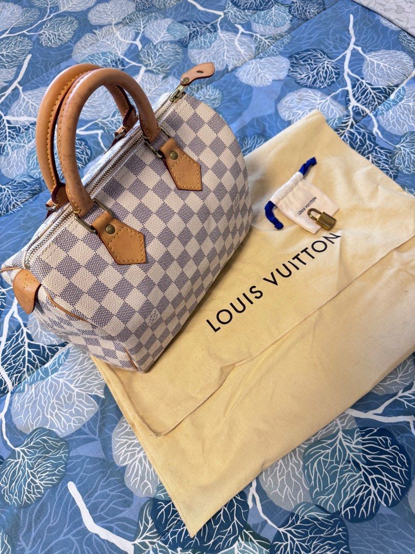 LV Speedy 25 in Damier Azur (Category: Luxury Bags & Wallets) located in Quezon City. Submitted by christineboller (Listing ID 1410925145, Image 2). Description: LV Speedy 25 in Damier Azur In 9.5/10 condition, very clean patina. Handle patina with light markings but can be cleaned. Very clean interior. Comes with dustbag and LV lock only (no key) for only P32k.