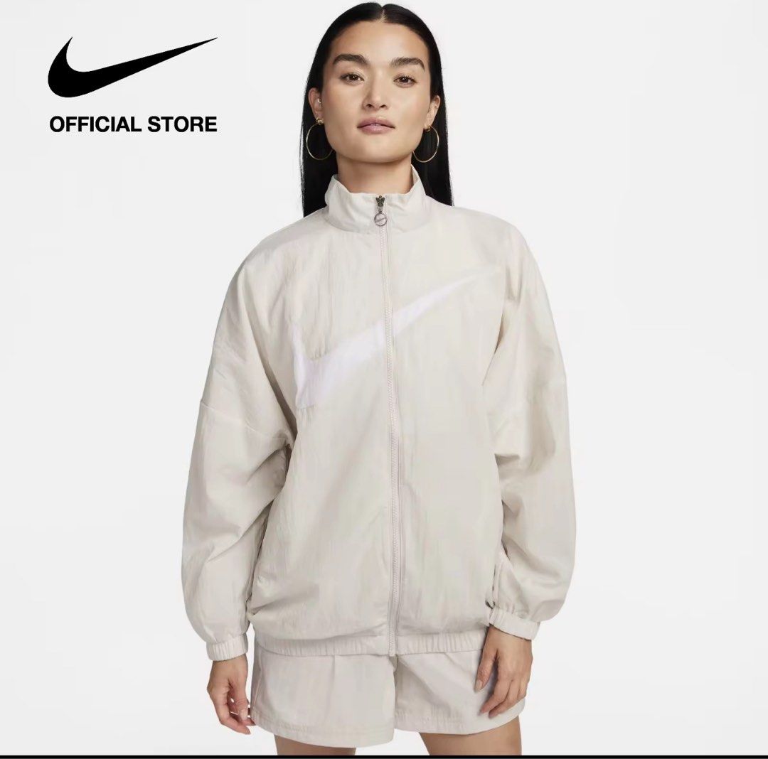 Nike Women's Oversized Woven Jacket (Category: Coats, Jackets and Outerwear) located in Manila. Submitted by luigeedeo (Listing ID 1411073102, Image 1). Description: - Nike oversized jacket - Light orewood brown color - Full zip closure - High collar - Large Nike swoosh logo - Oversized fit - Woven material - From the official Nike store.