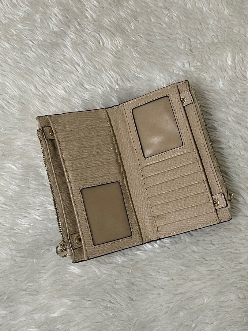 Parfois Beige Wallet (Category: Wallets & Card holders) located in Manila. Submitted by loveditemsbyj (Listing ID 1410941252, Image 3). Description: - Beige Parfois wallet - Multiple compartments for organization - Secure zippered closures - Stylish textured exterior - Includes card slots and clear ID windows - Features metal logo - Shows some wear on the edges.