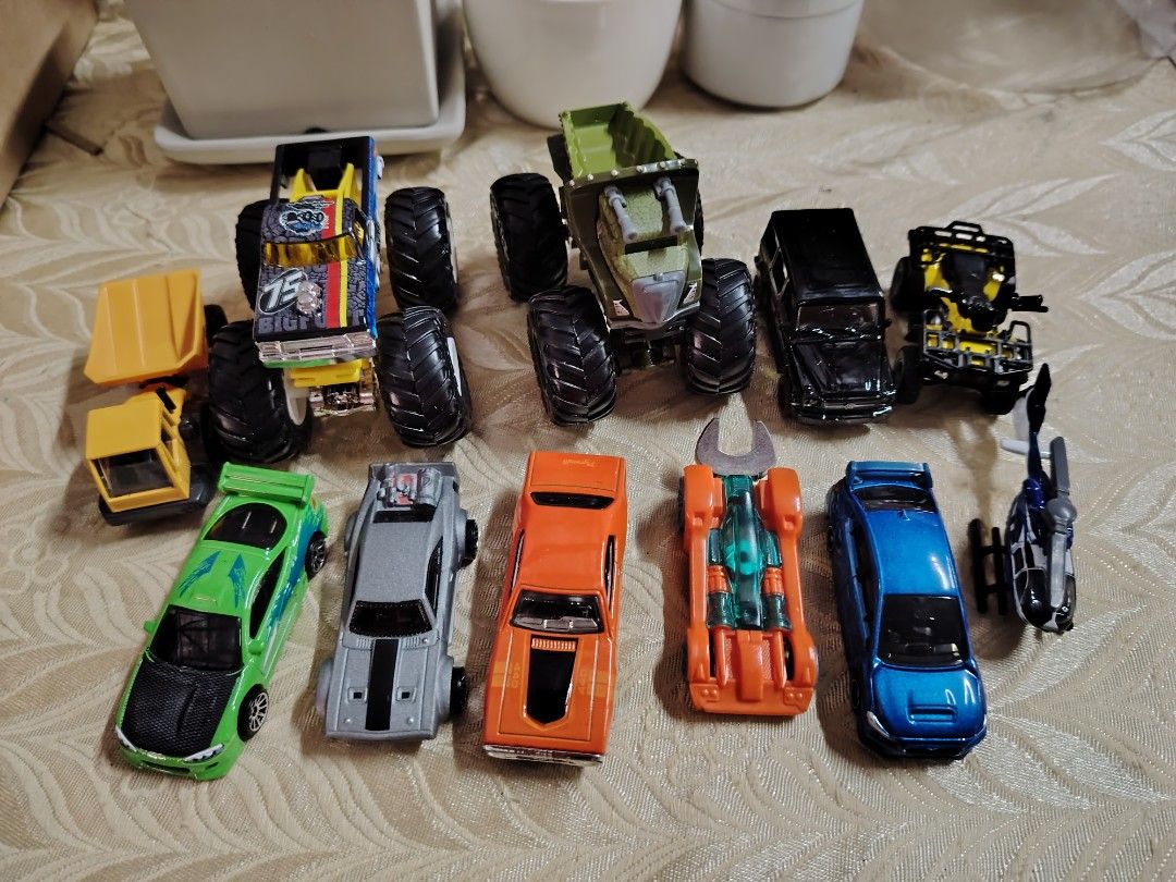 Assorted Toy Cars (Category: Vehicle & Diecast Models) located in Baguio. Submitted by thrifty_cool (Listing ID 1411132681, Image 1). Description: - Variety of toy cars: monster trucks, sports cars, and other vehicles. - Features different colors and designs. - Includes a yellow dump truck and a black SUV. - Ideal for kids or collectors. - Perfect for play or display. brands: Hotwheel, Tomica, Siku, Tomy.
