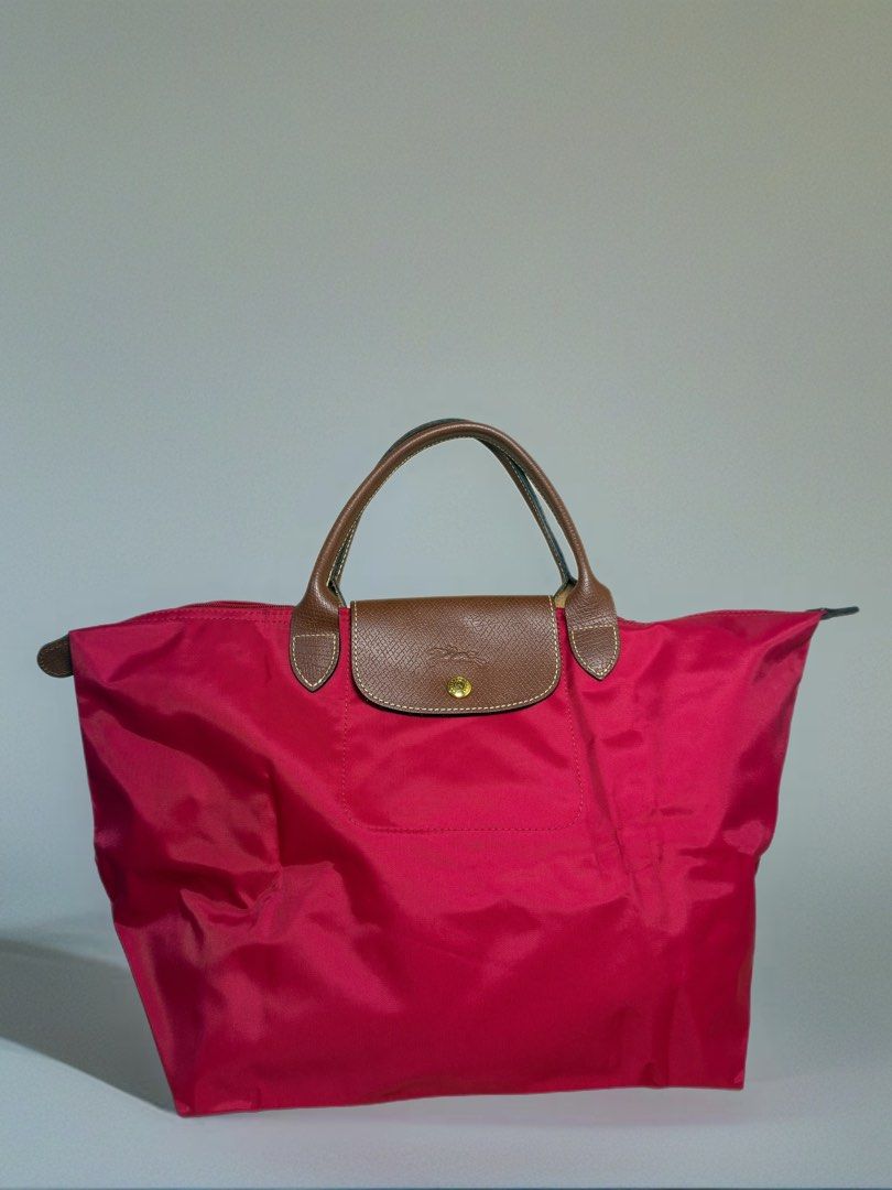 Authentic Longchamp Le Pliage Classic Medium Nylon Tote – Red (Category: Luxury Bags & Wallets) located in Pasig City. Submitted by chikaching (Listing ID 1411136593, Image 1). Description: Color: Red Model Code: CLA TWI/M/02 Condition: ✔️ Very good / like new condition ✔️ Nylon body, short leather handles and flap are all well-kept ✔️ Zipper and snap button fully functional ✔️ Few light stains inside from normal use (not noticeable when used) ✔️