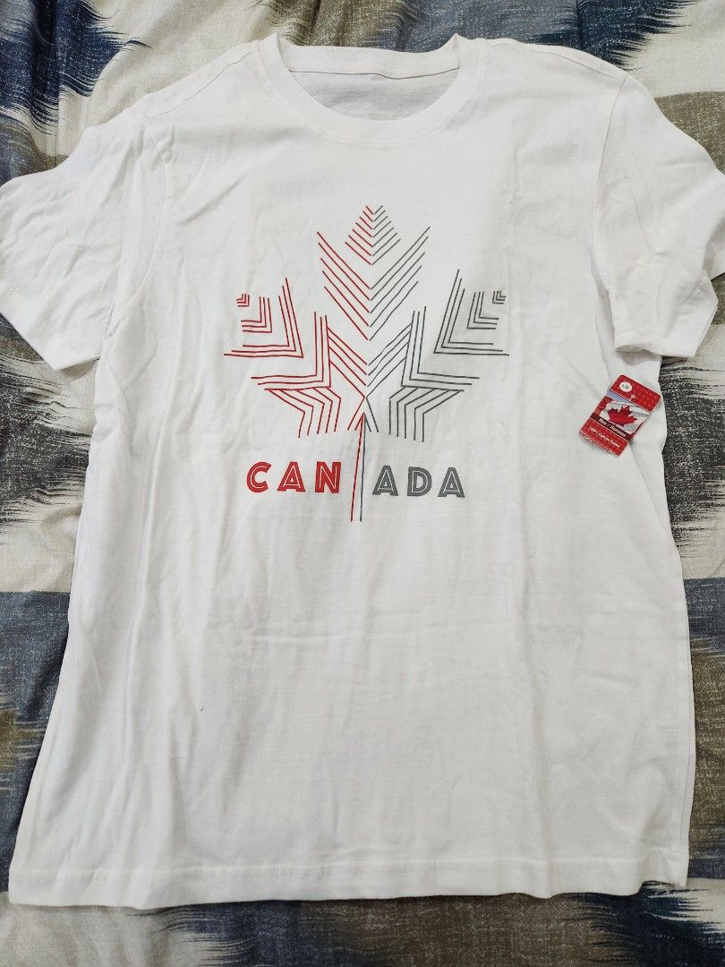 Canada Flag Graphic Men's Shirt (Category: Tshirts & Polo Shirts ) located in San Juan City. Submitted by iamryn (Listing ID 1411239274, Image 1). Description: - White t-shirt - Features a Canada flag graphic with snowflake design - Size: L - Made of 100% cotton - Brand new with tag **FREE if you purchase another of my item.